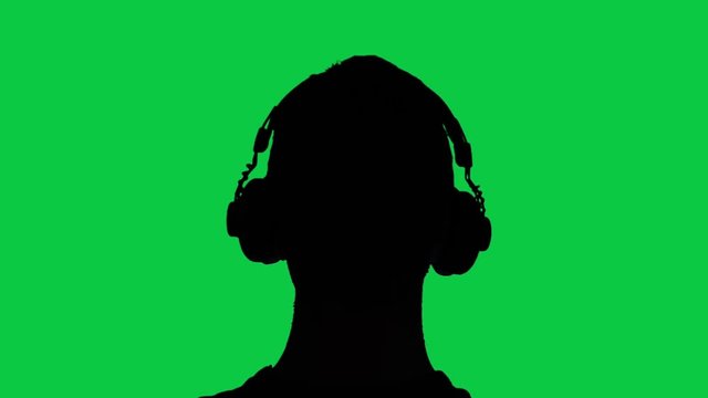 Silhouette of man with headphones, green screen