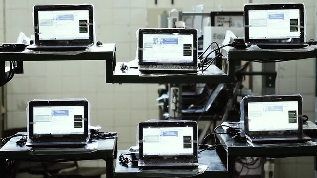 Computer Factory. Row of Laptop Computers in a Factory. Zoom Out.