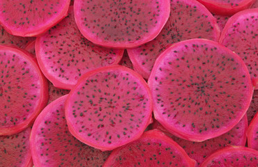 Fresh sliced red dragon fruit background, pitaya fruit texture