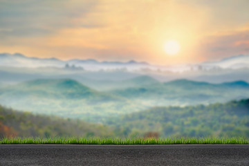 Paved road with blur view foggy winter sunrise in mountains natural background.