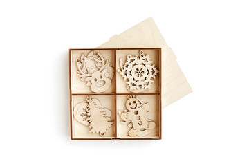 Набор украшений на елку из фанеры в виде различных символов Нового года. Изолированные на белом фоне. Вид сверху.