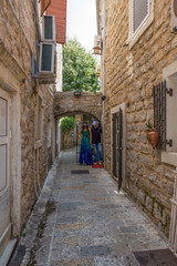 Fototapeta na wymiar Mannequins on a narrow street in the city of Budva in Montenegro