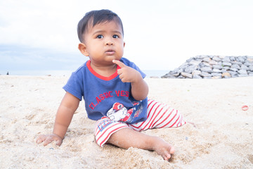 Little baby boy play on the beach