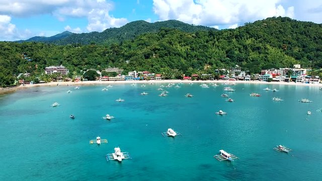 Wide aerial shot of El Nido Town and boats docked in the sea. El Nido, Palawan, Philippines