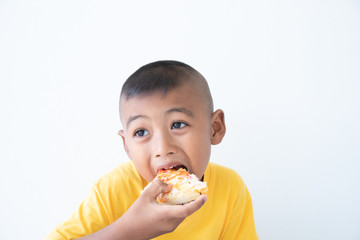 Cute asian boy eating pizza
