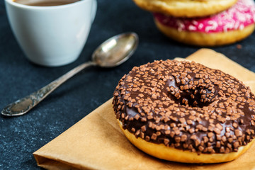 Sweet donuts on black stone table