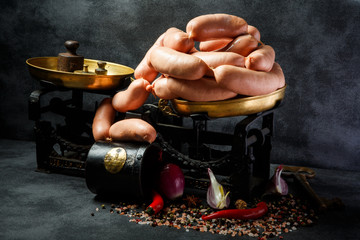 large pile of short thick wieners in spiral with onion and chili