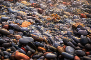Water flowing over stones at sunset