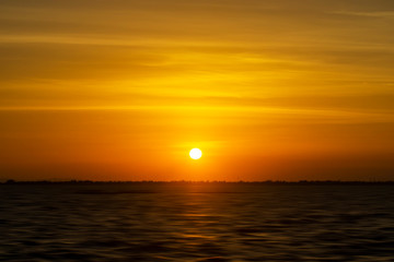 Sunset sky at the lake in golden hour.