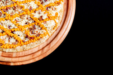 Half a pizza on top of a black background in close up
