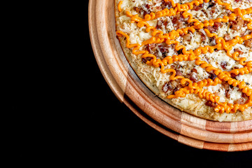 Half a pizza on top of a black background in close up