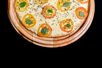 Half a pizza on top of a black background in close up