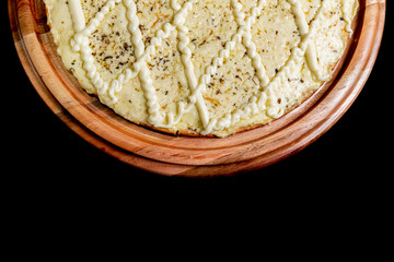 Half a pizza on top of a black background in close up