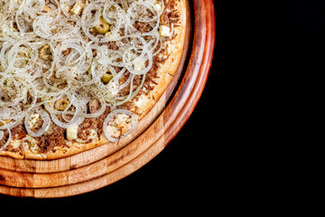 Half a pizza on top of a black background in close up