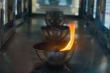 Candle flame on the lantern in Chinese temple.Thailand.