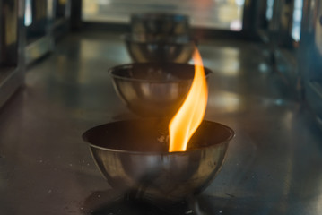 Candle flame on the lantern in Chinese temple.Thailand.