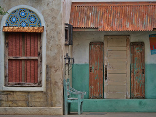 Tropical village building with weathered doors and window