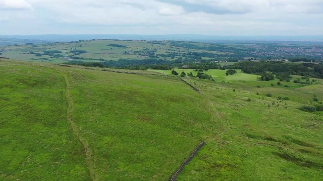 Drone footage flying over English countryside and hills