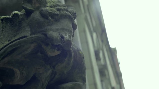 Stone gargoyle on the side of old court building in Manchester UK