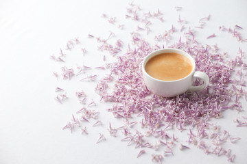 Morning Cup of coffee and a lilac flowers on light background, top view. Cozy Breakfast. Flat lay style. Female woman day, mother day, saint Valentine