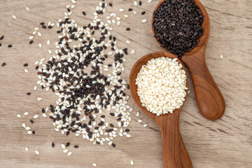 organic Black and White sesame seeds in wooden spoon ,healthy food for a reductions in both systolic and diastolic blood pressure