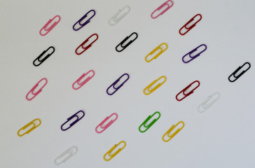 many multicolored clips on white paper