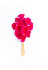  Red rose petals in the shape of ice cream on a stick on a white background.