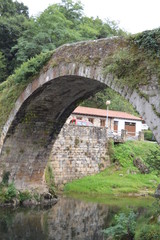 Fototapeta na wymiar Beautiful Roman Bridge That Really Was Built In The 16th Century By Bartolome De La Hermosa In Lierganes. August 24, 2013. Lierganes, Cantabria. Vacation Nature Street Photography.