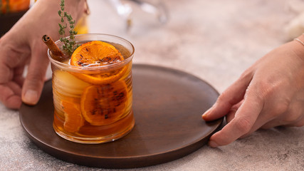 Hand holding  wooden try  with glass of Whiskey sour cocktail. Alcohol drink background.