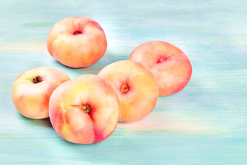 Saturn peaches on a teal background with copy space