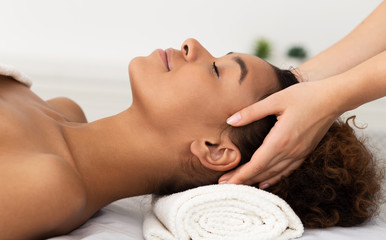 Obraz na płótnie Canvas Relaxing Massage. Afro Woman Receiving Head Massage