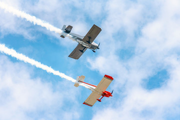 Two Planes in Formation Against a Blue Sky