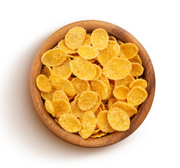 Corn flakes in wooden bowl isolated on white background, top view