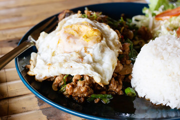 steamed rice and Fried Egg , Sunny up with stir-fried pork and basil