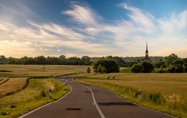 Asphalt road leading to the German village