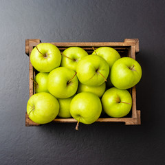 Green apples on black table