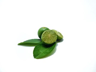 fresh lime fruit and leaves on white background