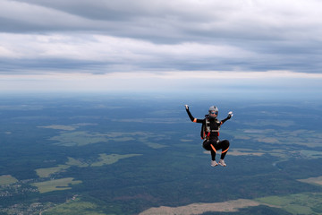 Skydiving. The alone girl is in the sky.