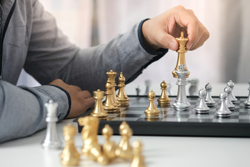 Businessman play with chess game. success management concept of business strategy and tactic...