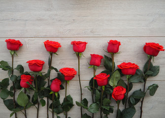 Fototapeta na wymiar Red roses on wooden background