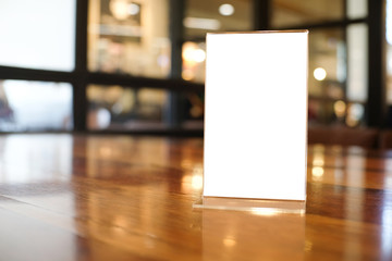 Menu frame space for text marketing promotion standing on wood table in Bar restaurant cafeใ