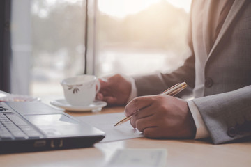 A businessman calculating income and expenses in his own company