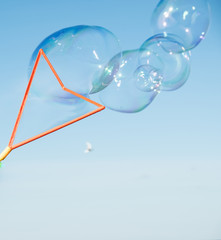 Large, soap bubbles against the blue sky. Lake Ladoga, sunny day.