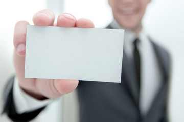 businessman showing a blank business card