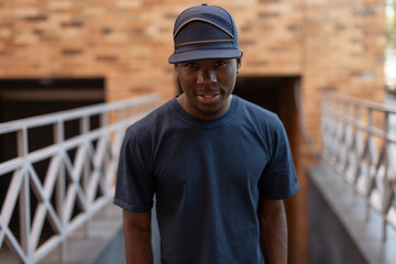 Stylish and modern african american man posing in urban city place