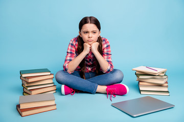 Portrait of her she nice attractive smart clever disappointed girl wearing checked shirt sitting in lotus pose waiting inspiration isolated over bright vivid shine blue green background