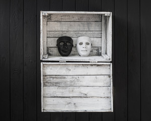 black and white mask on a white wooden background