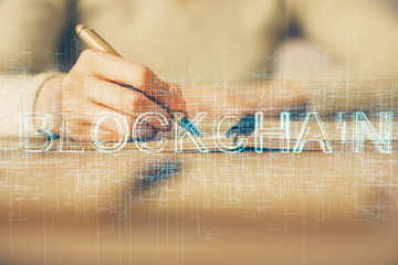 Cryptocurrency hologram over woman's hands writing background. Concept of blockchain. Multi exposure