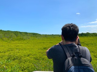 Man taking photo in the field