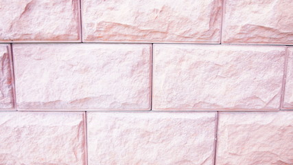 Unevenly treated surface of a pinkish-colored stone